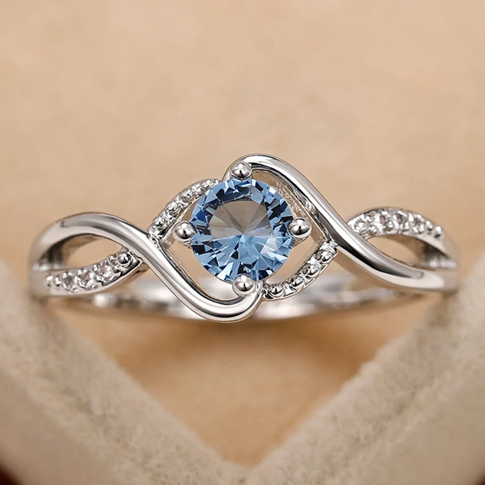 Azure Serenity: 925 Sterling Silver Twisted Infinity Ring with Sky Blue Crystal