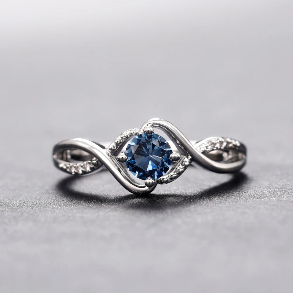 Azure Serenity: 925 Sterling Silver Twisted Infinity Ring with Sky Blue Crystal