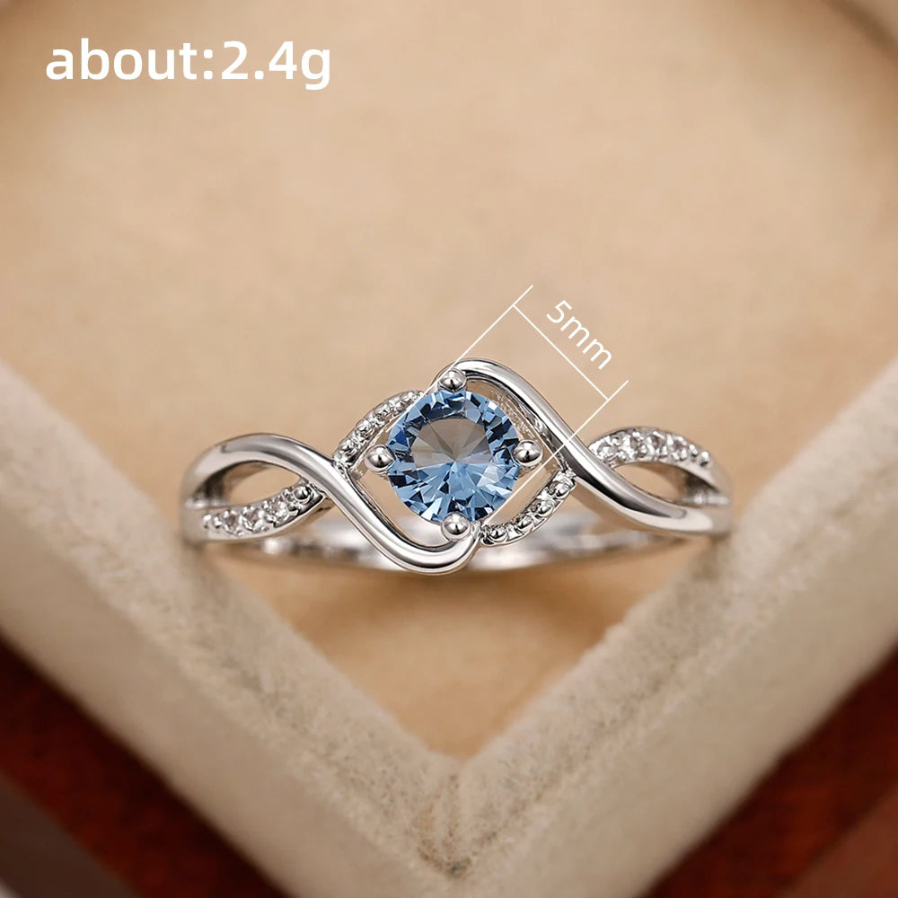 Azure Serenity: 925 Sterling Silver Twisted Infinity Ring with Sky Blue Crystal
