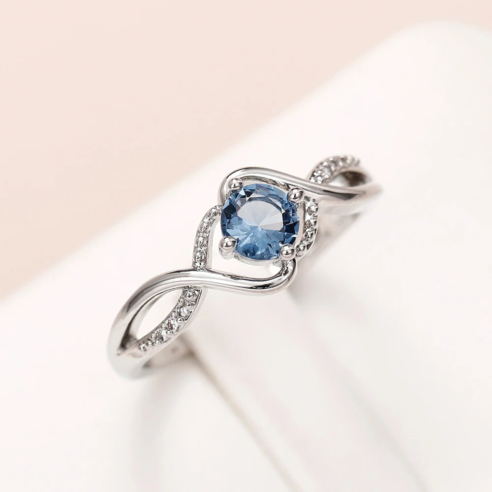Azure Serenity: 925 Sterling Silver Twisted Infinity Ring with Sky Blue Crystal