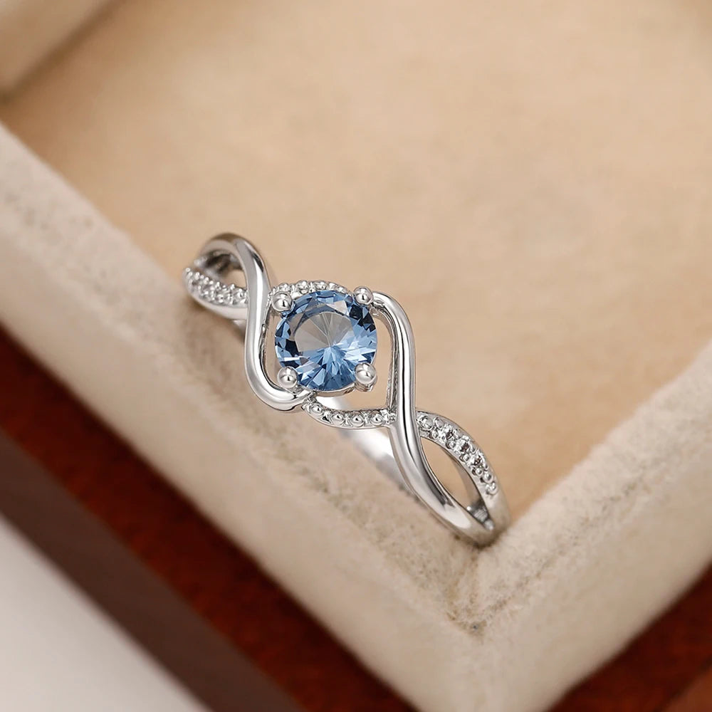 Azure Serenity: 925 Sterling Silver Twisted Infinity Ring with Sky Blue Crystal